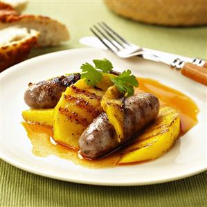 Two sausages with grilled mango slices