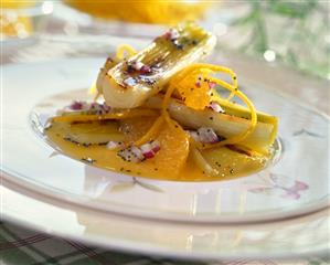 Grilled leeks a l'orange with poppy seeds and onions