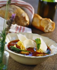 Spicy bouillon with saucisse and tortellini