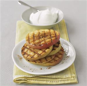 Grilled apple slices with a small bowl of quark