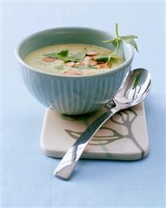 Potato soup with parsley and flaked almonds in small bowl