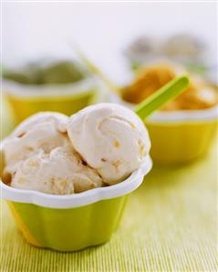 Orange and honey ice cream with raisins in a small bowl