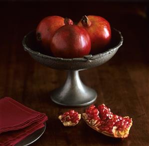 Three pomegranates in a bowl