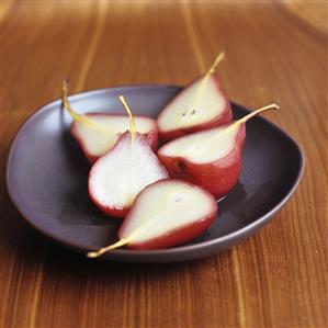 Five pear halves poached in red wine