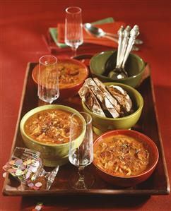 Spicy cabbage soup with bread on a tray for New Year's Eve