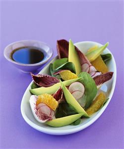 Avocado salad with radish slices and orange segments