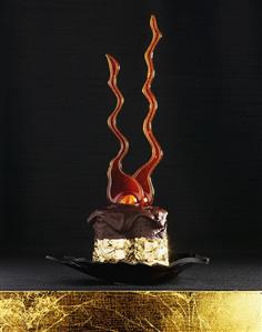 Small chocolate cake with caramel decoration