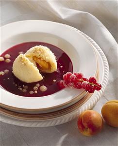 Apricot dumpling with redcurrant sauce