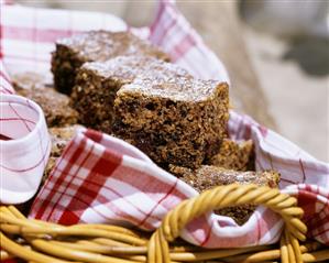 Chocolate cherry cake in pieces in picnic basket (1)