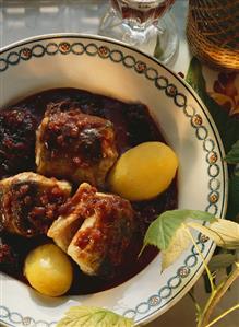 Pieces of eel in red wine sauce with prunes & potatoes