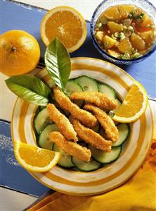 Coconut chicken on cucumber slices with orange dip