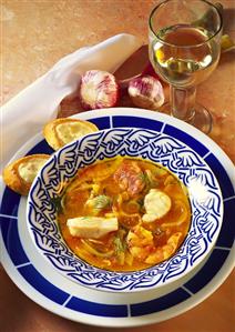 Fish and shrimp soup with onions, tomatoes & dill