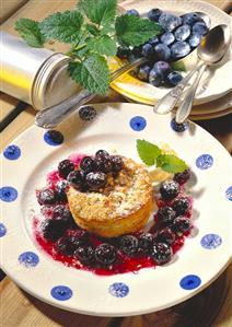 Small round cake with blueberries, almonds & icing sugar