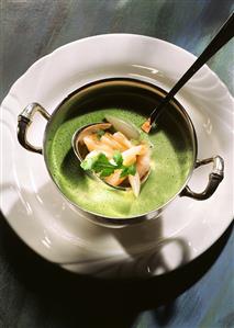 Cream of rocket soup with white radishes & shrimps on ladle