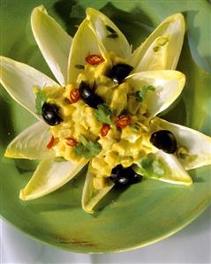 Chicory salad with curry mousse, grapes, chili & pistachios