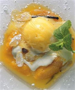 Apricot ice cream on apricot compote with cream, almonds & mint