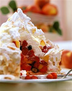 Coconut meringue gateau with summer fruit on plate (1)