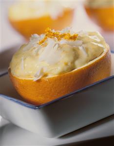 Orange mousse with white chocolate curls in orange halves