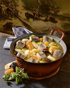 Hamburg eel soup with dried fruit in pot in front old painting