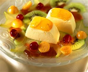 Orange mousse with marinated fruit on plate