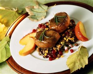 Venison steaks with bacon lentils, apple slices & cranberries