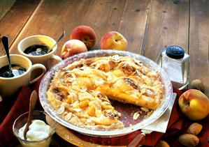 Peach tart, piece cut, with ginger & almonds; coffee