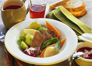 Beef with vegetables and beetroot sauce on plate