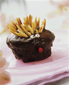 Hedgehog muffins with chocolate icing and almond slivers