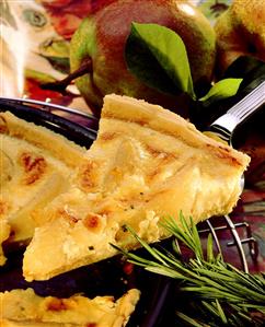 Cheese tart with pears on cake slice above baking dish