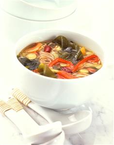 Kombu soup with beans, peppers & leeks in white bowl