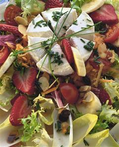 Salad leaves with goat's cheese and fruit (filling the picture)