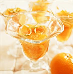 Orange dessert with lime zest in glass dishes