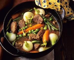 Beef stew with vegetables in cast-iron pan