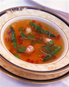 Crab soup with asparagus, diced tomatoes and fresh herbs