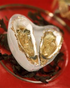 Oysters in a heart-shaped block of ice on a glass plate