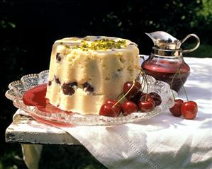 Semolina pudding with cherries and pistachios on a table