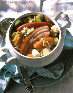 Hearty stew with boiling sausage, pork and vegetables