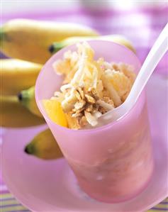 Muesli with bananas and oranges in jar with spoon (1)