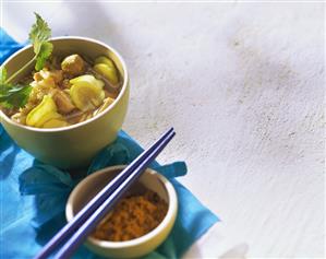 Chicken and courgette soup with rice in bowl; curry powder (1)