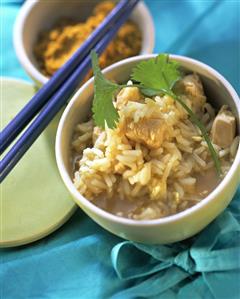 Poultry soup with rice and coriander in a bowl; Curry