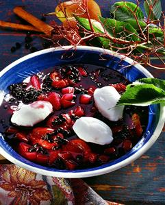 Elderberry soup with egg white dumplings in deep plate