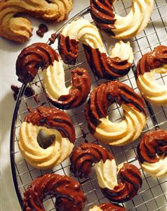 Piped biscuits with chocolate icing on cake rack