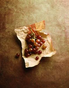 Red grapes on wrapping paper