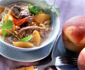 Duck curry with honey and peaches in sauce