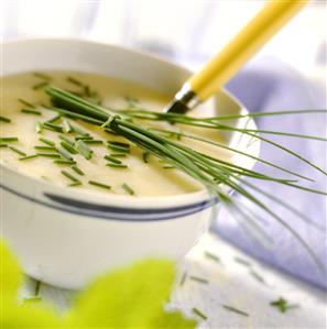 Kohlrabi soup with chives in a soup bowl