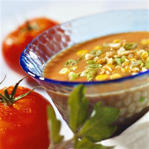 Tomato soup with sweetcorn, peanuts and spring onions