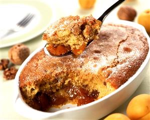 Apricot semolina pudding on spoon and in baking dish