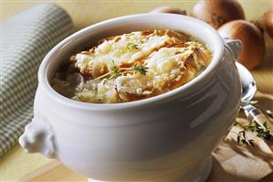 Onion soup with toasted bread & cheese in soup tureen