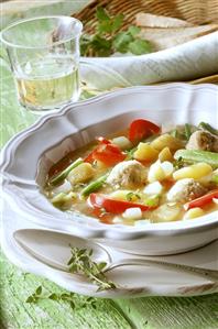 Vegetable stew & dumplings, white wine glass, bread in basket