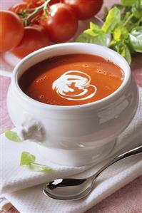 Cream of tomato soup in white soup tureen